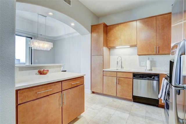 kitchen with decorative light fixtures, tasteful backsplash, sink, stainless steel appliances, and crown molding