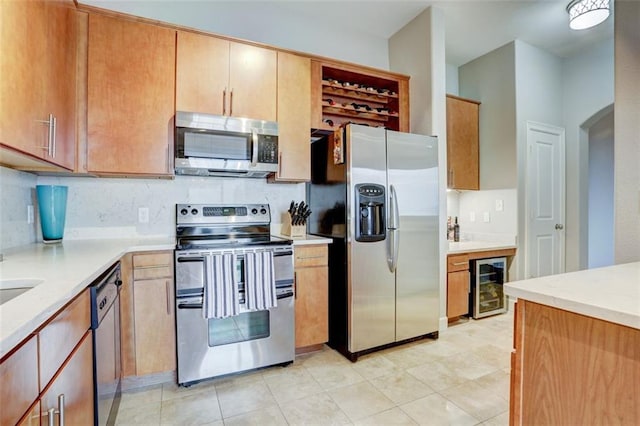 kitchen with stainless steel appliances, wine cooler, and decorative backsplash