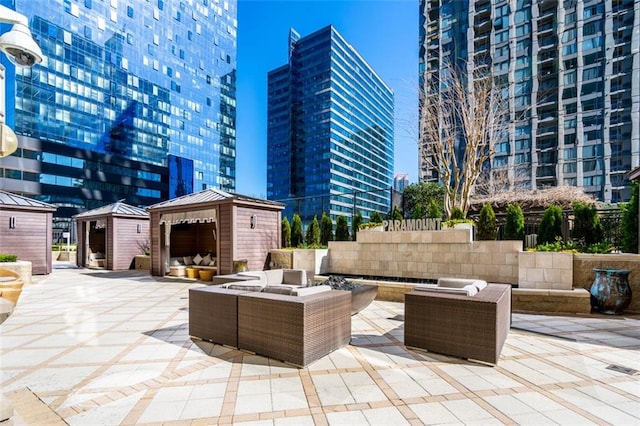 view of patio with a storage shed, a gazebo, and an outdoor hangout area