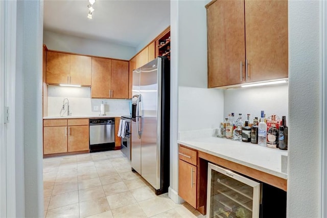 kitchen with stainless steel appliances, sink, and wine cooler