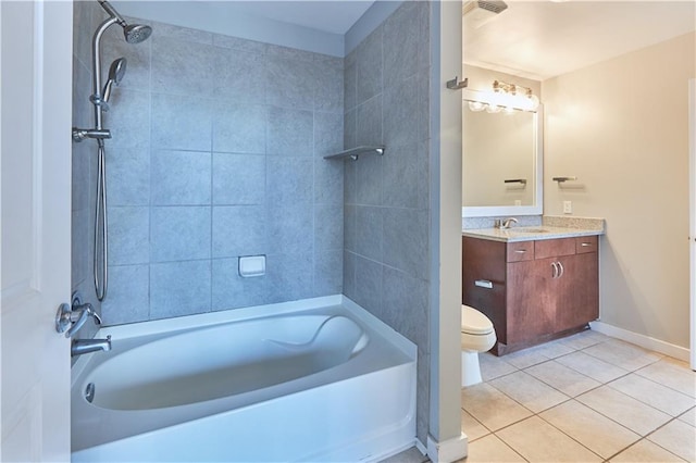 full bathroom featuring tiled shower / bath, vanity, toilet, and tile patterned flooring