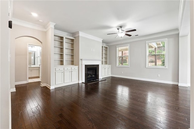 4090 Danbury Farms Dr, Cumming, GA 30040 - unfurnished living room with a ceiling fan, arched walkways, dark wood-style floors, baseboards, and a fireplace