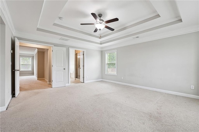 4090 Danbury Farms Dr, Cumming, GA 30040 - unfurnished bedroom featuring ornamental molding, a tray ceiling, multiple windows, light carpet, and baseboards