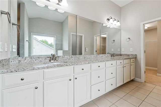 4090 Danbury Farms Dr, Cumming, GA 30040 - full bath featuring double vanity, tile patterned flooring, a walk in closet, baseboards, and a shower