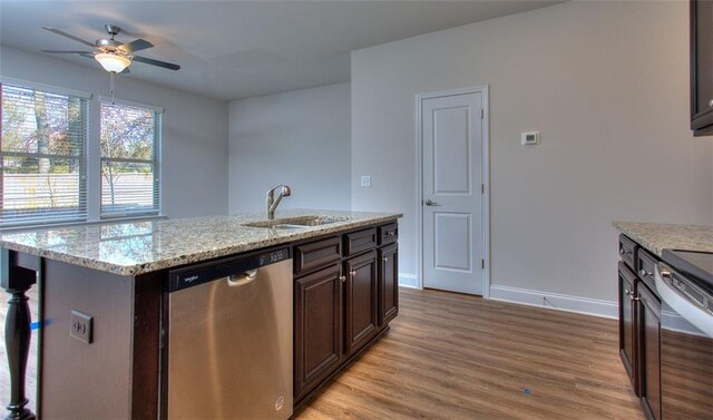 kitchen featuring light hardwood / wood-style floors, dark brown cabinets, ceiling fan, a center island with sink, and stainless steel dishwasher