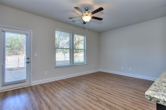 interior space with ceiling fan and hardwood / wood-style flooring