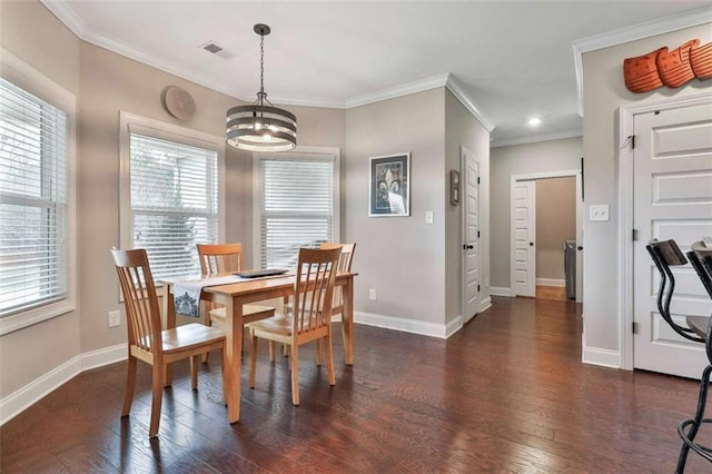 dining room with dark wood-type flooring, an inviting chandelier, and crown molding