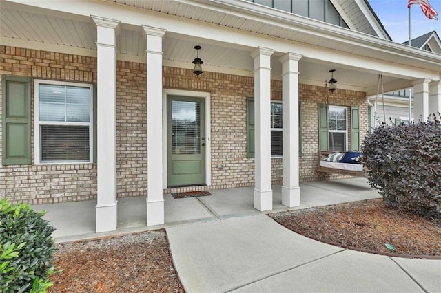 view of exterior entry with covered porch