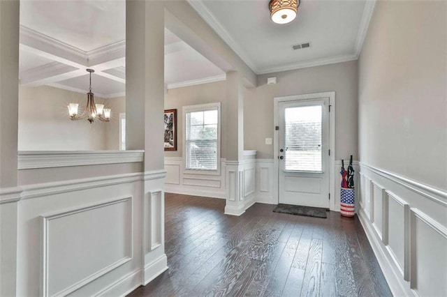 entryway with a chandelier, dark hardwood / wood-style flooring, ornamental molding, and coffered ceiling