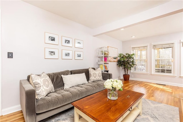 living room featuring hardwood / wood-style floors and beam ceiling