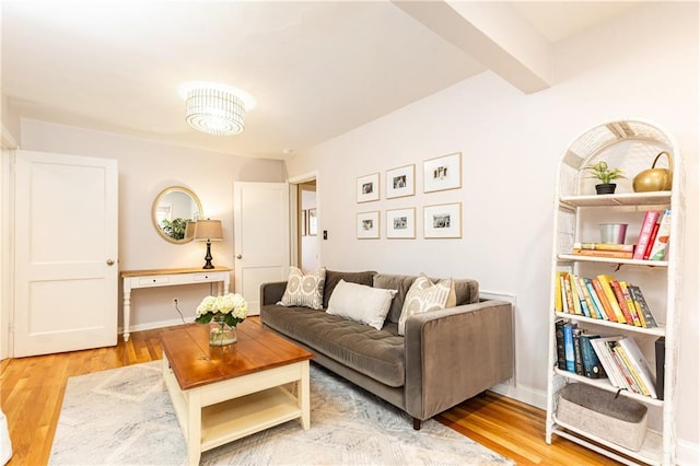 living room with beam ceiling and light hardwood / wood-style flooring