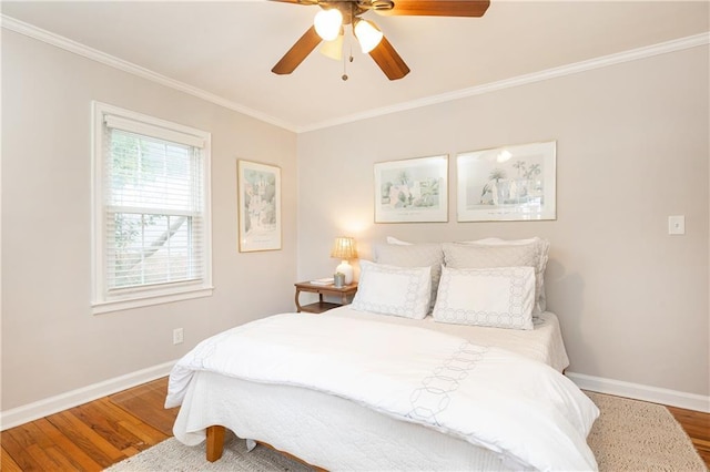 bedroom featuring crown molding, hardwood / wood-style floors, and ceiling fan