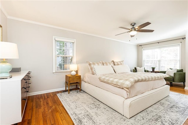 bedroom with multiple windows, crown molding, hardwood / wood-style flooring, and ceiling fan