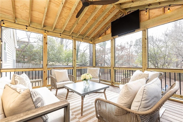 sunroom with ceiling fan and lofted ceiling