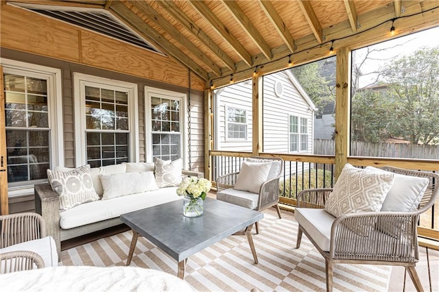 sunroom featuring lofted ceiling and wooden ceiling