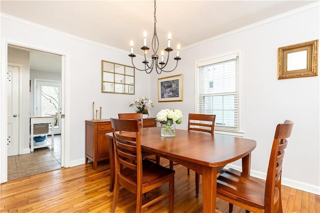 dining space featuring an inviting chandelier, wood-type flooring, and ornamental molding