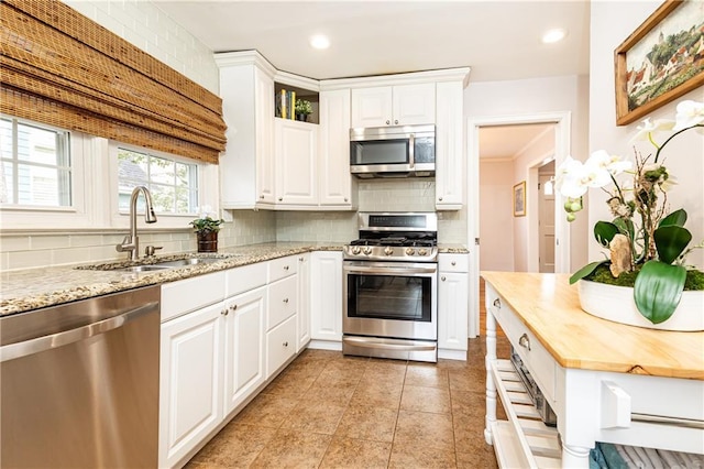 kitchen featuring white cabinetry, stainless steel appliances, and sink