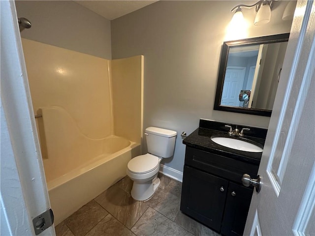 full bathroom featuring toilet, vanity, tub / shower combination, and baseboards