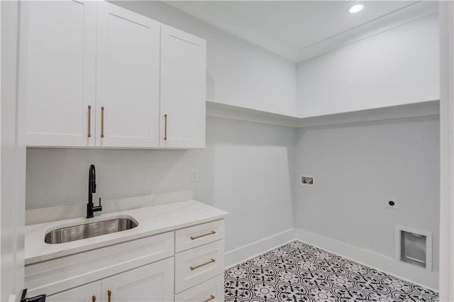 clothes washing area featuring hookup for a washing machine, baseboards, hookup for an electric dryer, cabinet space, and a sink