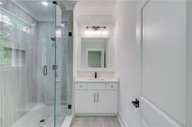 bathroom with a shower stall and vanity