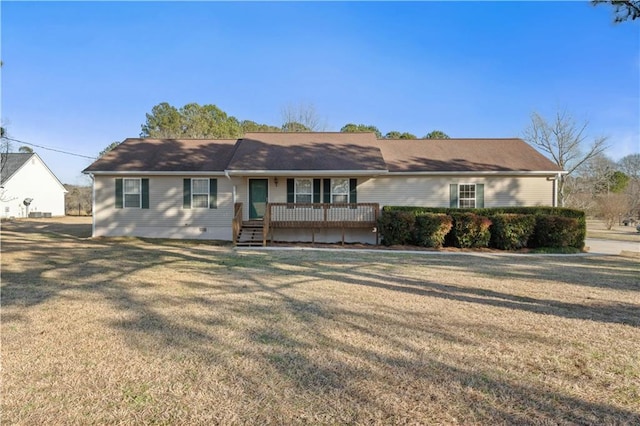 single story home with a wooden deck and a front yard