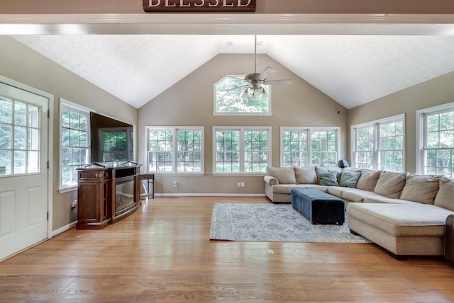 sunroom featuring ceiling fan and lofted ceiling