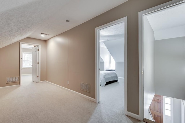 bonus room featuring light carpet and lofted ceiling