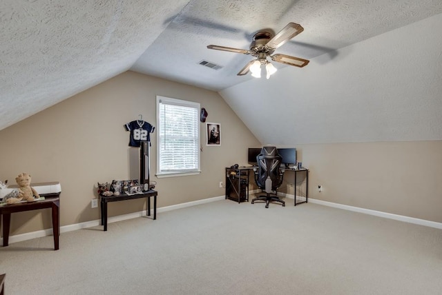 carpeted office space featuring a textured ceiling, ceiling fan, and lofted ceiling