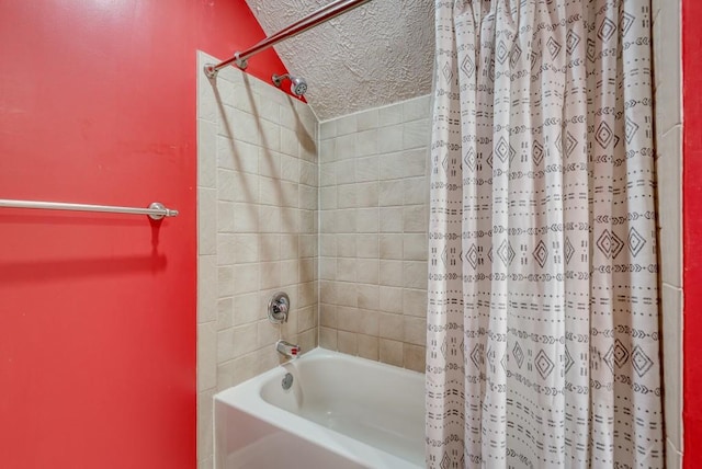 bathroom featuring a textured ceiling and tiled shower / bath combo