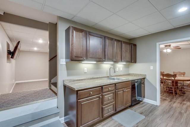 kitchen featuring dark brown cabinetry, ceiling fan, sink, dishwasher, and light hardwood / wood-style floors