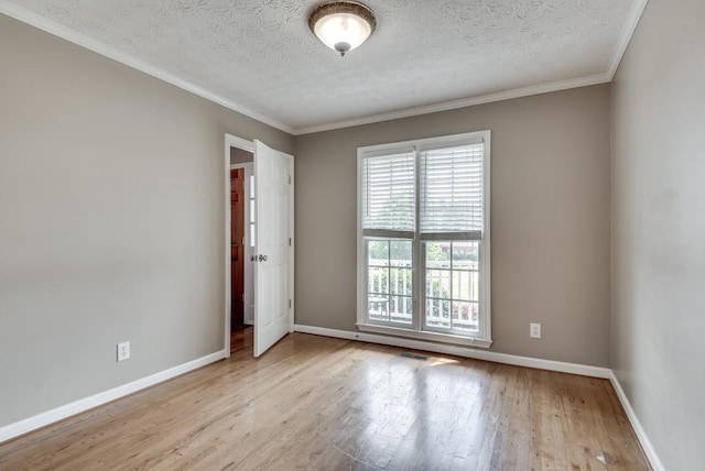 unfurnished room featuring ornamental molding, a textured ceiling, and light wood-type flooring