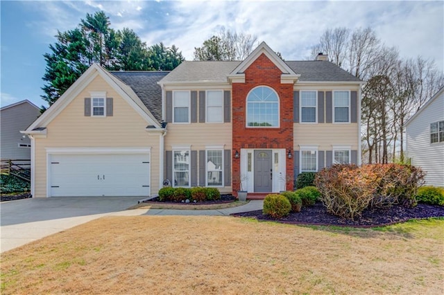 colonial inspired home with a front yard, concrete driveway, brick siding, and a garage