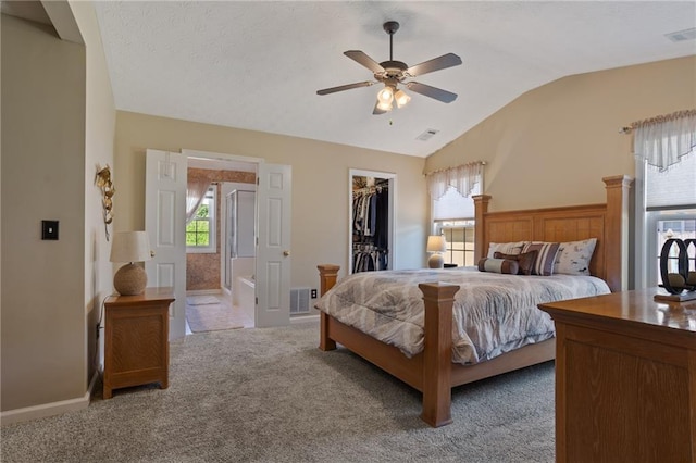 bedroom featuring lofted ceiling, visible vents, a spacious closet, and carpet floors