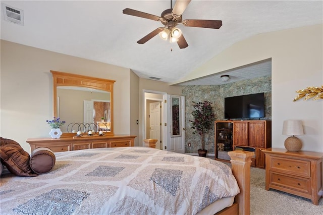 carpeted bedroom featuring vaulted ceiling, visible vents, and ceiling fan