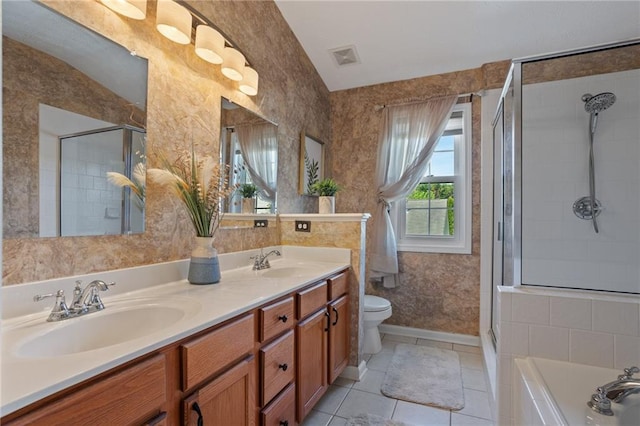 full bath featuring toilet, a sink, tile patterned floors, and a stall shower