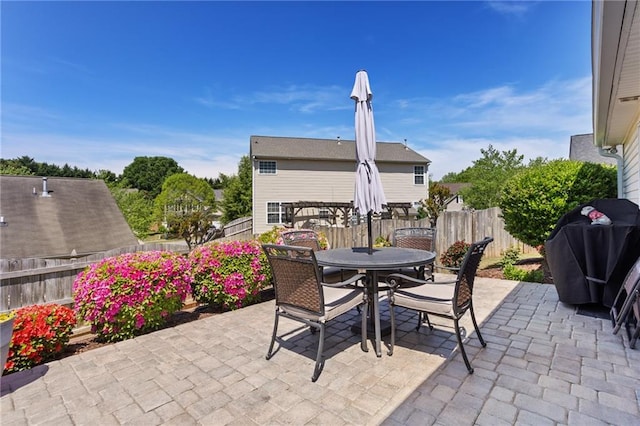 view of patio / terrace featuring outdoor dining space, area for grilling, and a fenced backyard