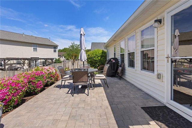 view of patio / terrace featuring fence and outdoor dining space