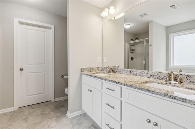 bathroom featuring vanity, toilet, and walk in shower