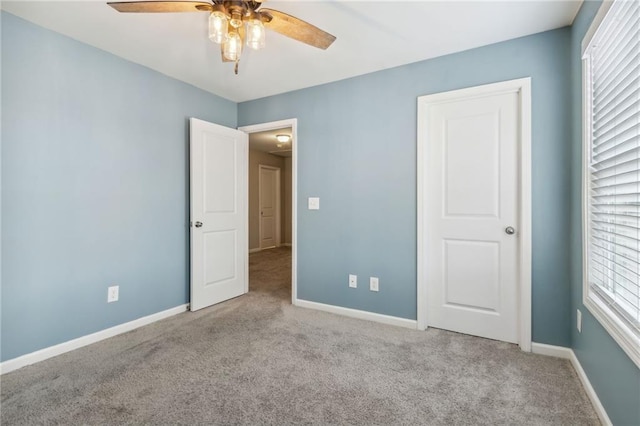 unfurnished bedroom featuring ceiling fan and light carpet