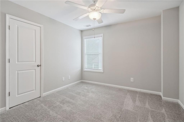 unfurnished room with ceiling fan and light colored carpet