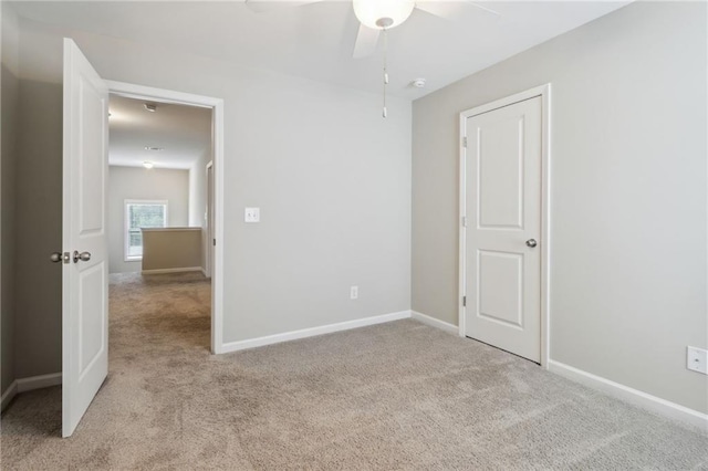 unfurnished bedroom with light colored carpet and ceiling fan