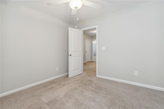 empty room with ceiling fan and light colored carpet