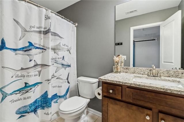 bathroom featuring tile patterned flooring, vanity, and toilet