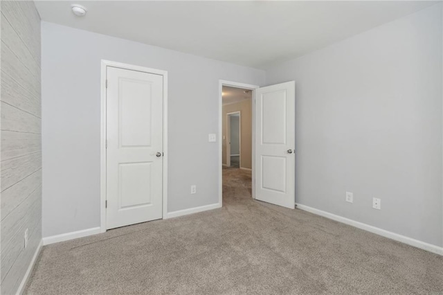 unfurnished room featuring light carpet