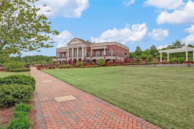 surrounding community with a yard and a pergola