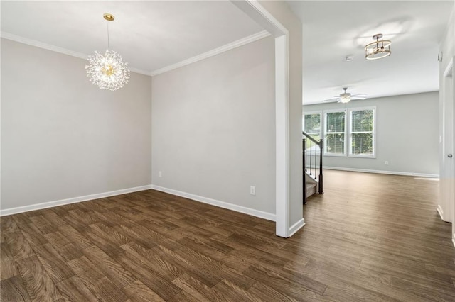 empty room with ceiling fan with notable chandelier, dark hardwood / wood-style flooring, and crown molding