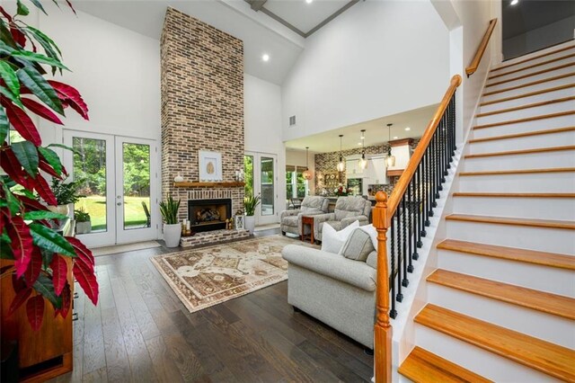 400 Fox Valley Dr, Monroe, GA 30656 - living area featuring high vaulted ceiling, stairway, dark wood-style flooring, french doors, and a fireplace