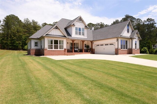 400 Fox Valley Dr, Monroe, GA 30656 - view of front of house featuring driveway, a front yard, an attached garage, board and batten siding, and a porch