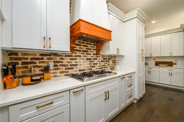 400 Fox Valley Dr, Monroe, GA 30656 - kitchen with stainless steel gas stovetop, custom exhaust hood, light countertops, dark wood finished floors, and decorative backsplash