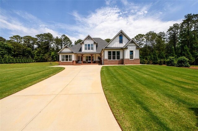 400 Fox Valley Dr, Monroe, GA 30656 - view of front of property with brick siding, a porch, a front lawn, and concrete driveway